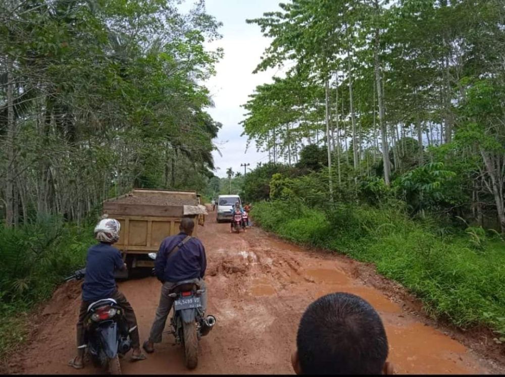 Tampak pengendara sepeda motor antri untuk melintas di ruas jalan Desa Lubuk Ruso, Kecamatan Pemayung, Kabupaten Batanghari yang rusak parah....